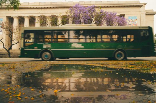 Colectivo driving along a Buenos Aires avenue, illustrating the Buenos Aires bus fare