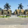 Plaza de Armas in Lima, Peru, with palm trees and people walking on a sunny day