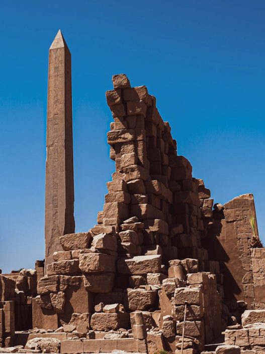Egyptian obelisks at the Karnak temple complex in Luxor under a clear blue sky