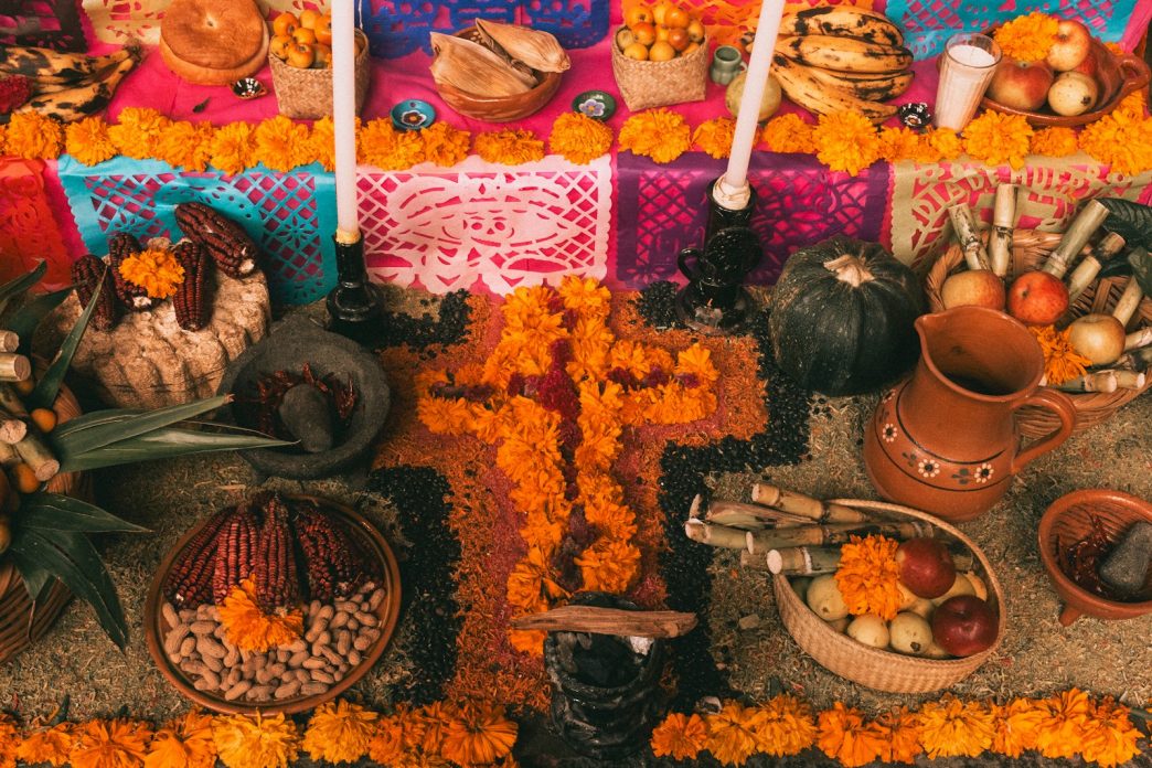 Day of the Dead ofrenda in Mexico with bread, fruit and marigold flowers