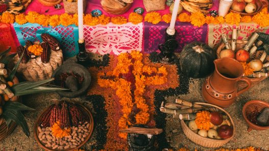 Day of the Dead ofrenda in Mexico with bread, fruit and marigold flowers