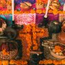 Day of the Dead ofrenda in Mexico with bread, fruit and marigold flowers