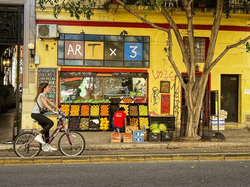 Buenos Aires street with a fruit stand, a shop where Pix in Argentina may be accepted