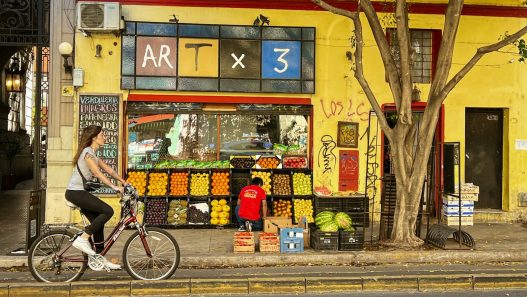 Buenos Aires street with a fruit stand, a shop where Pix in Argentina may be accepted