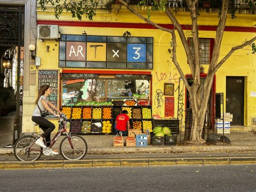 Buenos Aires street with a fruit stand, a shop where Pix in Argentina may be accepted